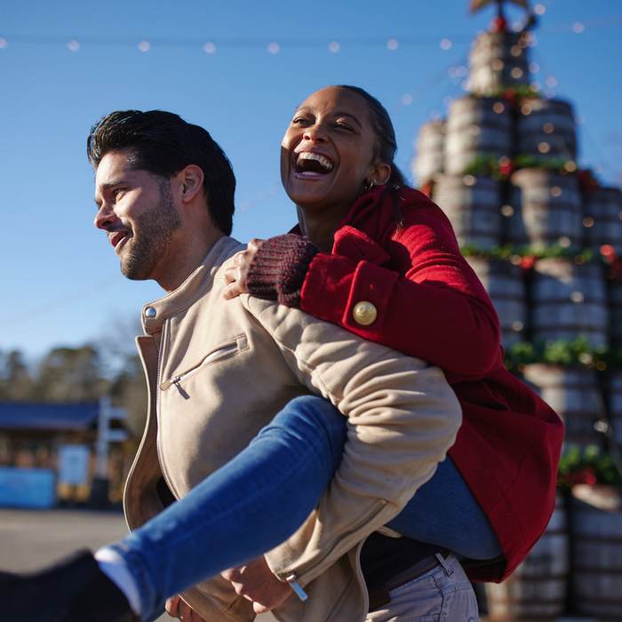 Couple laughing in front of decorated tanks